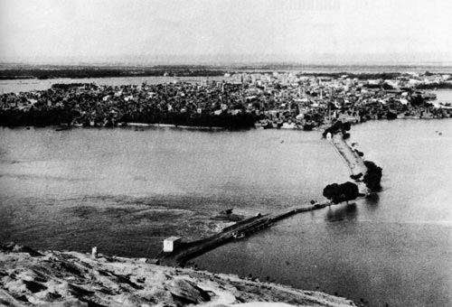 Photograph, early 1900s, of Asyut during the inundation.  Clearly showing the impact of the annual flood, the town is effectively an island.